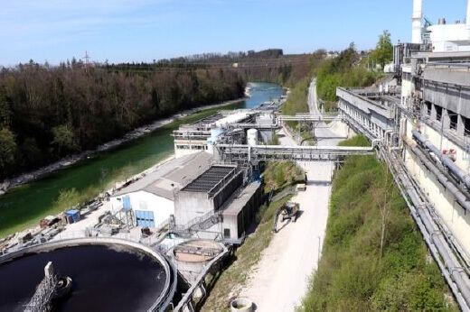 Aerial view of a wastewater treatment plant beside a river